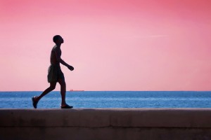 Boy Walking on Malecon Wall